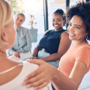 women in group supporting one another