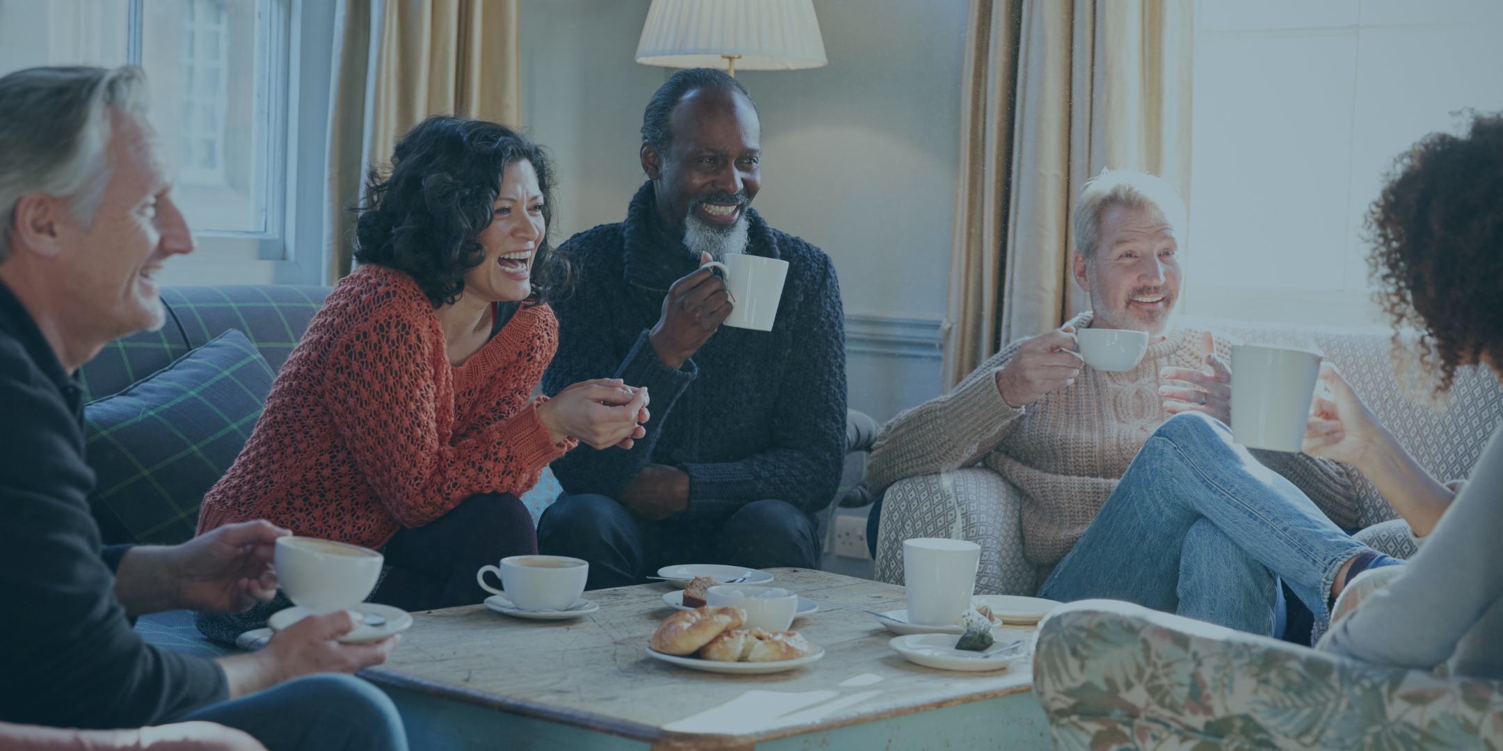 Military and veteran spouses enjoying morning coffee and chatting in a group, peer-support setting.